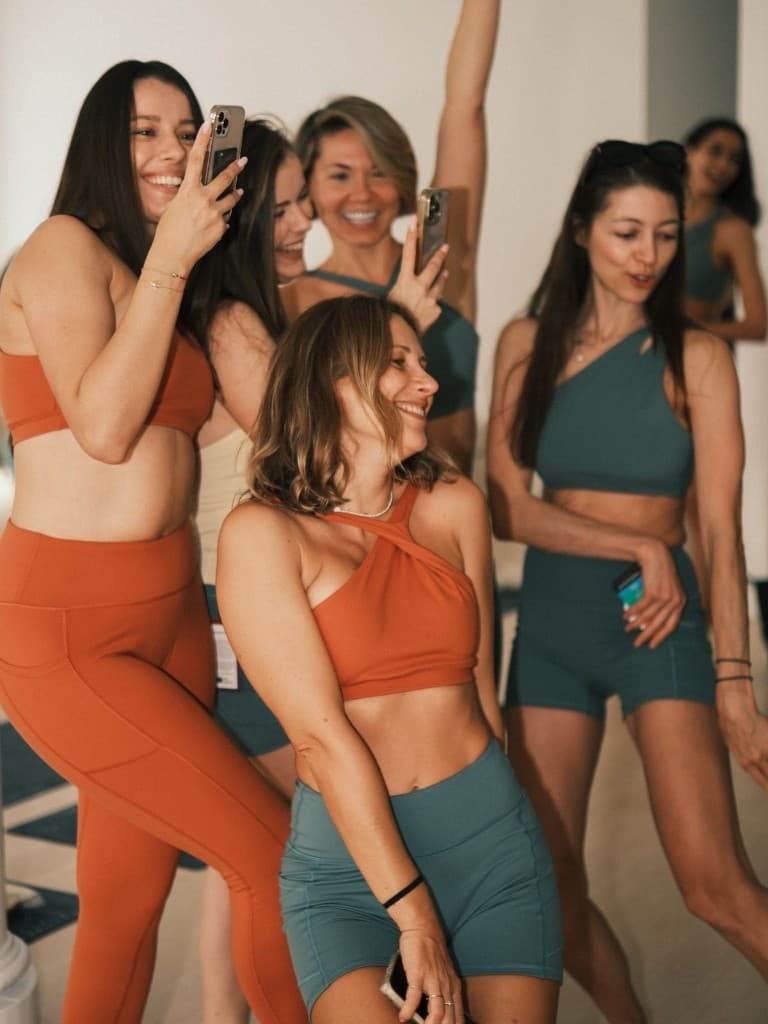A group in neutral workout clothes standing together