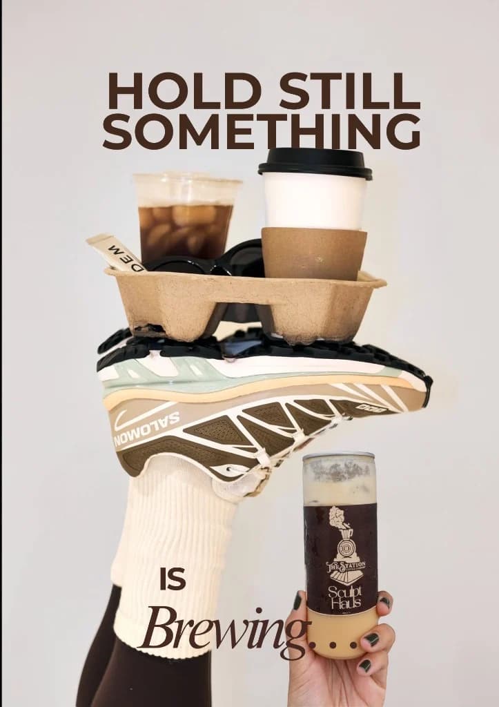 A poster that reads hold still, something is brewing, with coffee and a sneaker